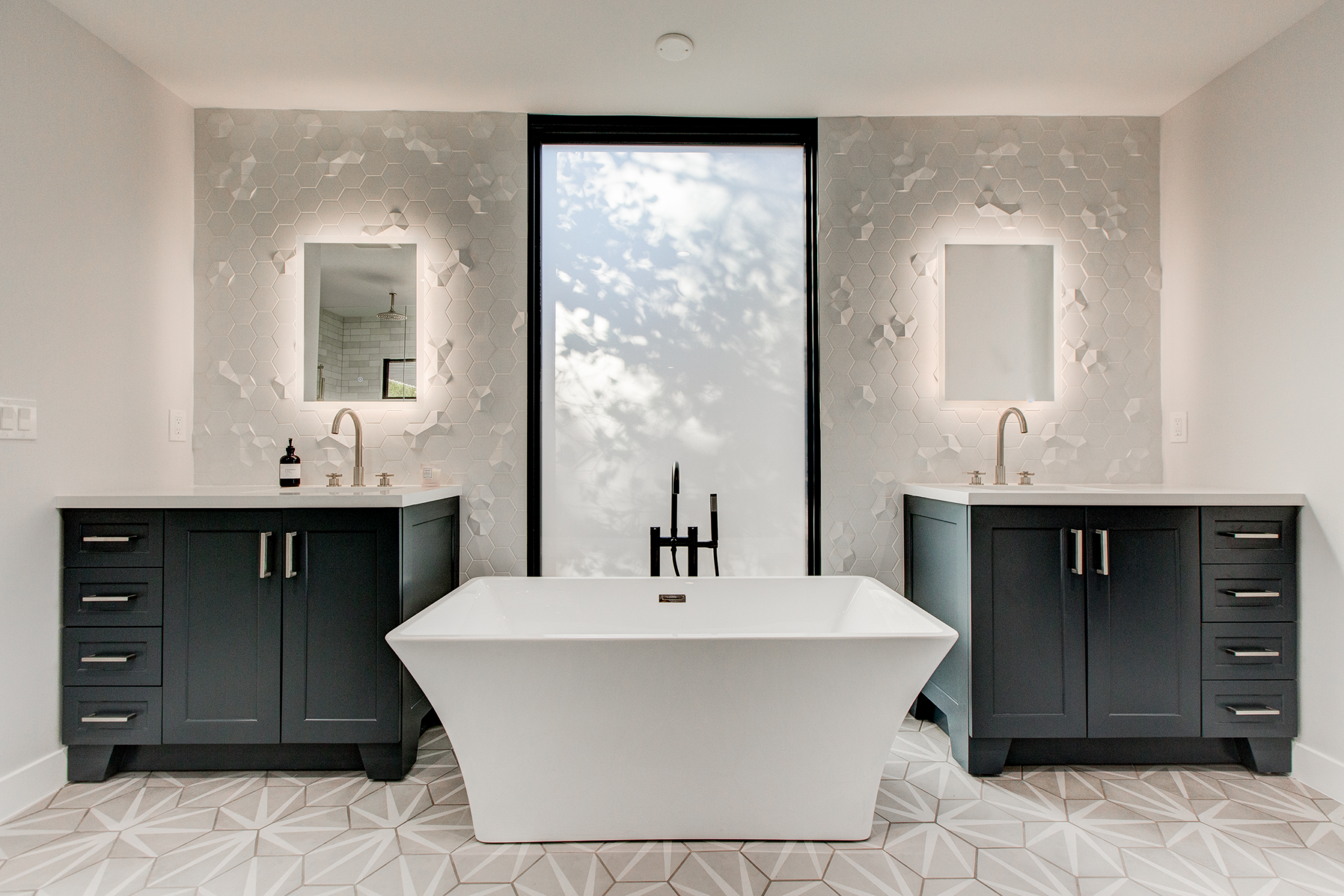 Professional photo of master bath tub and vanities for property listing.